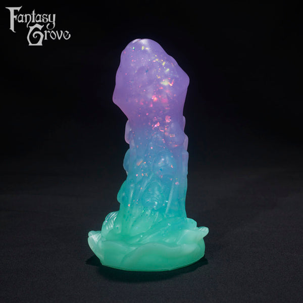 A Fantasy Grove sex toy on a black background with a logo in the upper left corner