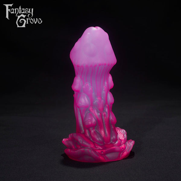 A Fantasy Grove sex toy on a black background with a logo in the upper left corner