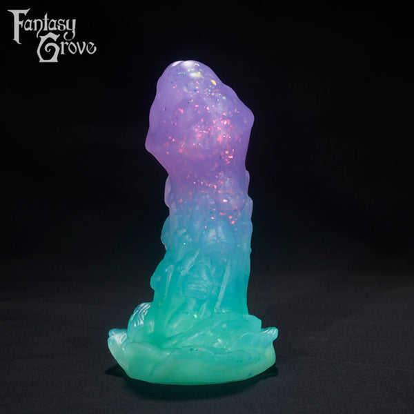 A Fantasy Grove sex toy on a black background with a logo in the upper left corner