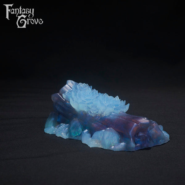 A Fantasy Grove sex toy on a black background with a logo in the upper left corner