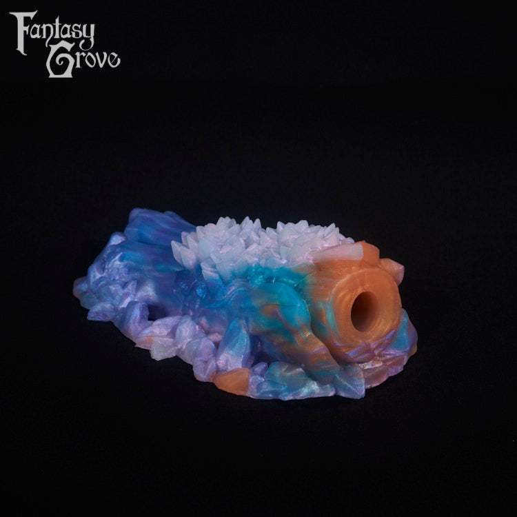A fantasy sex toy on a black background with the Fantasy Grove logo in the upper left corner