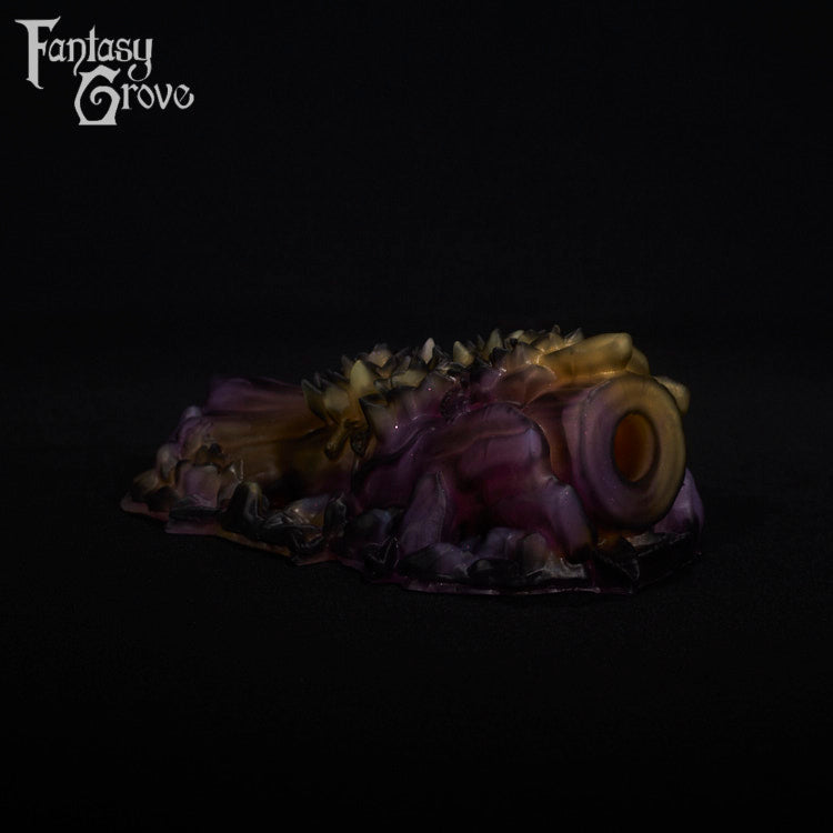 A fantasy sex toy on a black background with the Fantasy Grove logo in the upper left corner