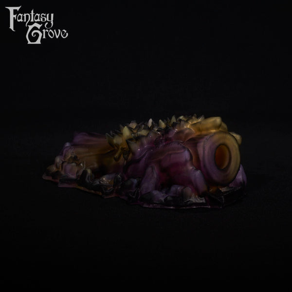 A fantasy sex toy on a black background with the Fantasy Grove logo in the upper left corner