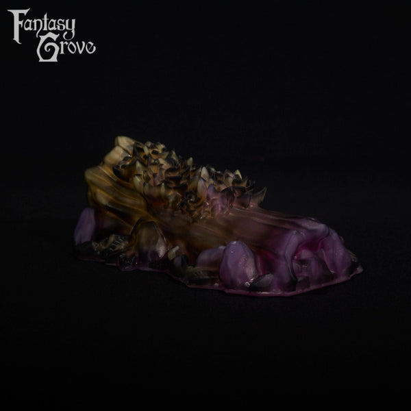 A fantasy sex toy on a black background with the Fantasy Grove logo in the upper left corner