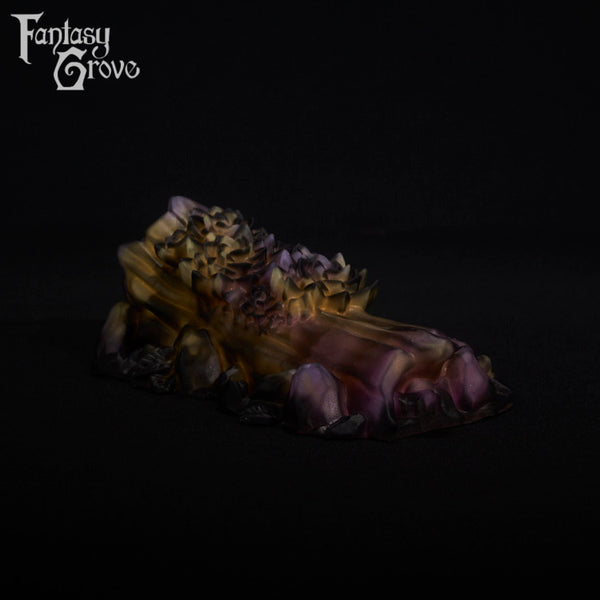 A fantasy sex toy on a black background with the Fantasy Grove logo in the upper left corner
