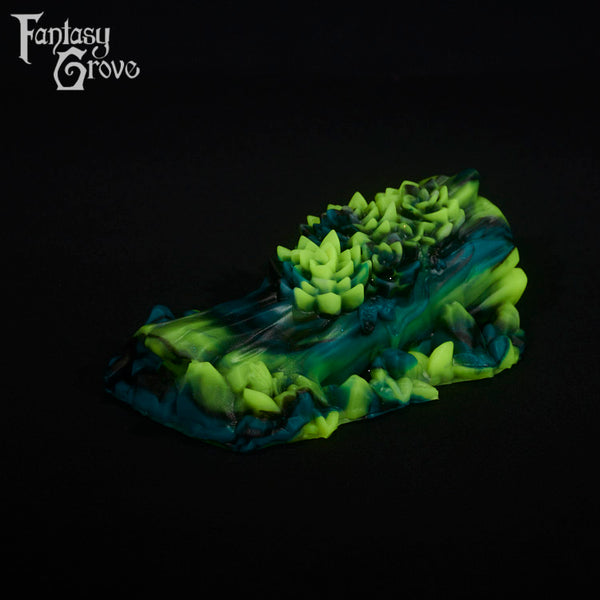 A fantasy sex toy on a black background with the Fantasy Grove logo in the upper left corner