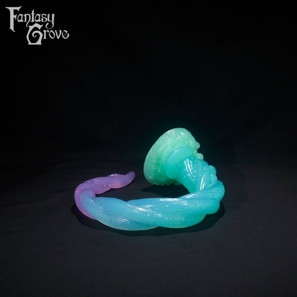 A Fantasy Grove sex toy on a black background with a logo in the upper left corner