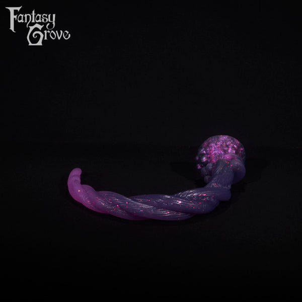 A fantasy sex toy on a black background with the Fantasy Grove logo in the upper left corner